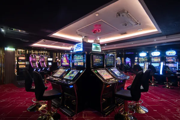 A woman in a luxurious green gown next to an ornate roulette wheel, capturing the upscale casino mood of BD9.